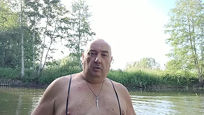 The plump, mustachioed daddy is having a blast in the stream, shamelessly masturbating with mud