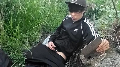 Cute Asian gay twink in a black-and-white adidas tracksuit and Campus sneakers masturbates and cums outdoors