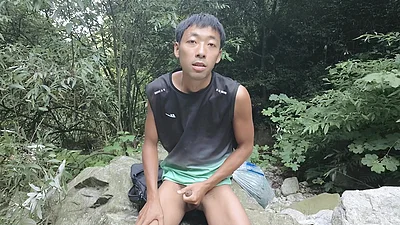 A wild boy masturbates, moaning and ejaculating by a stream in the deep mountains, and then eats his own semen